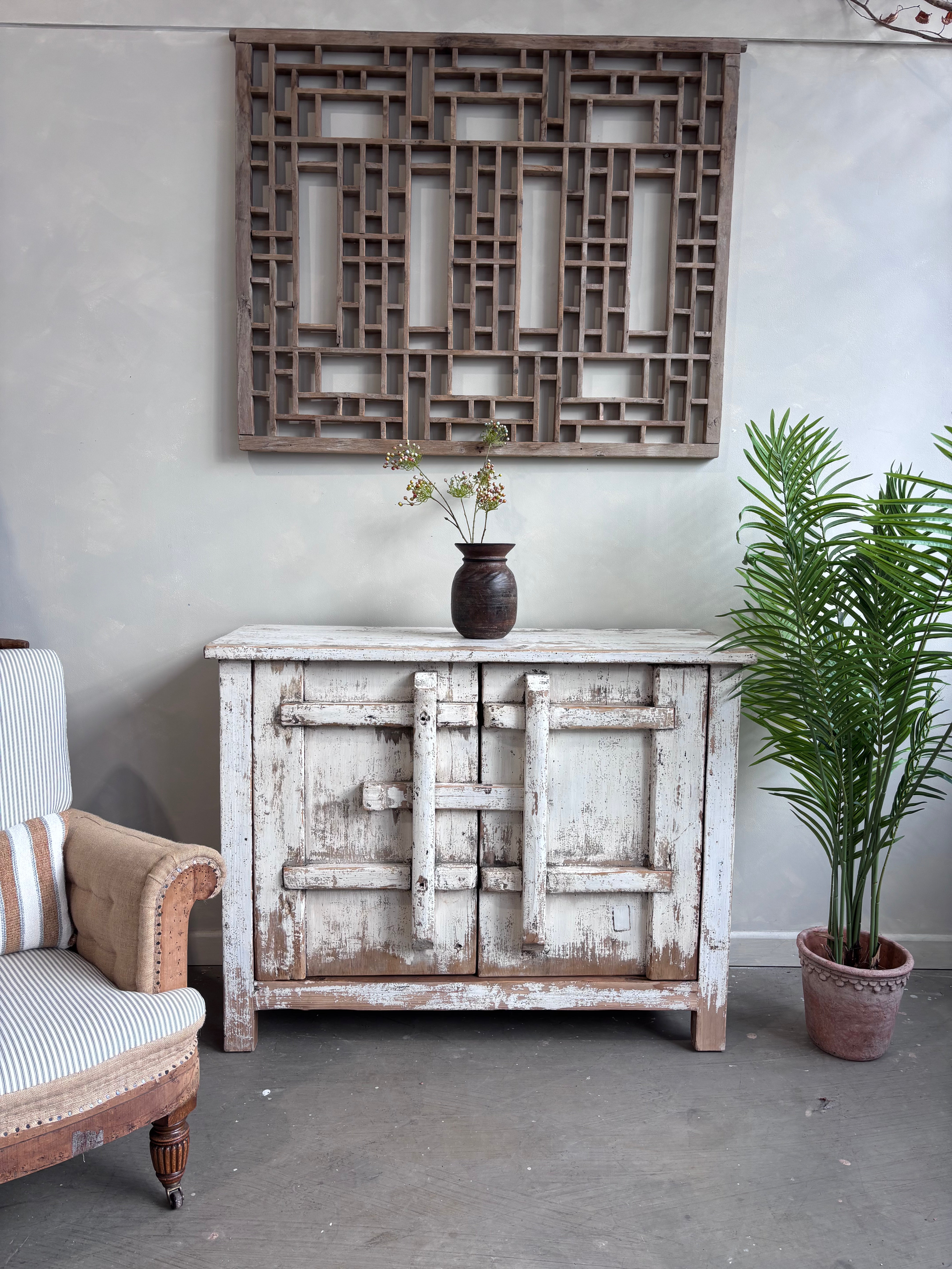 Distressed White Two Door Elm Cabinet with Unique Doors