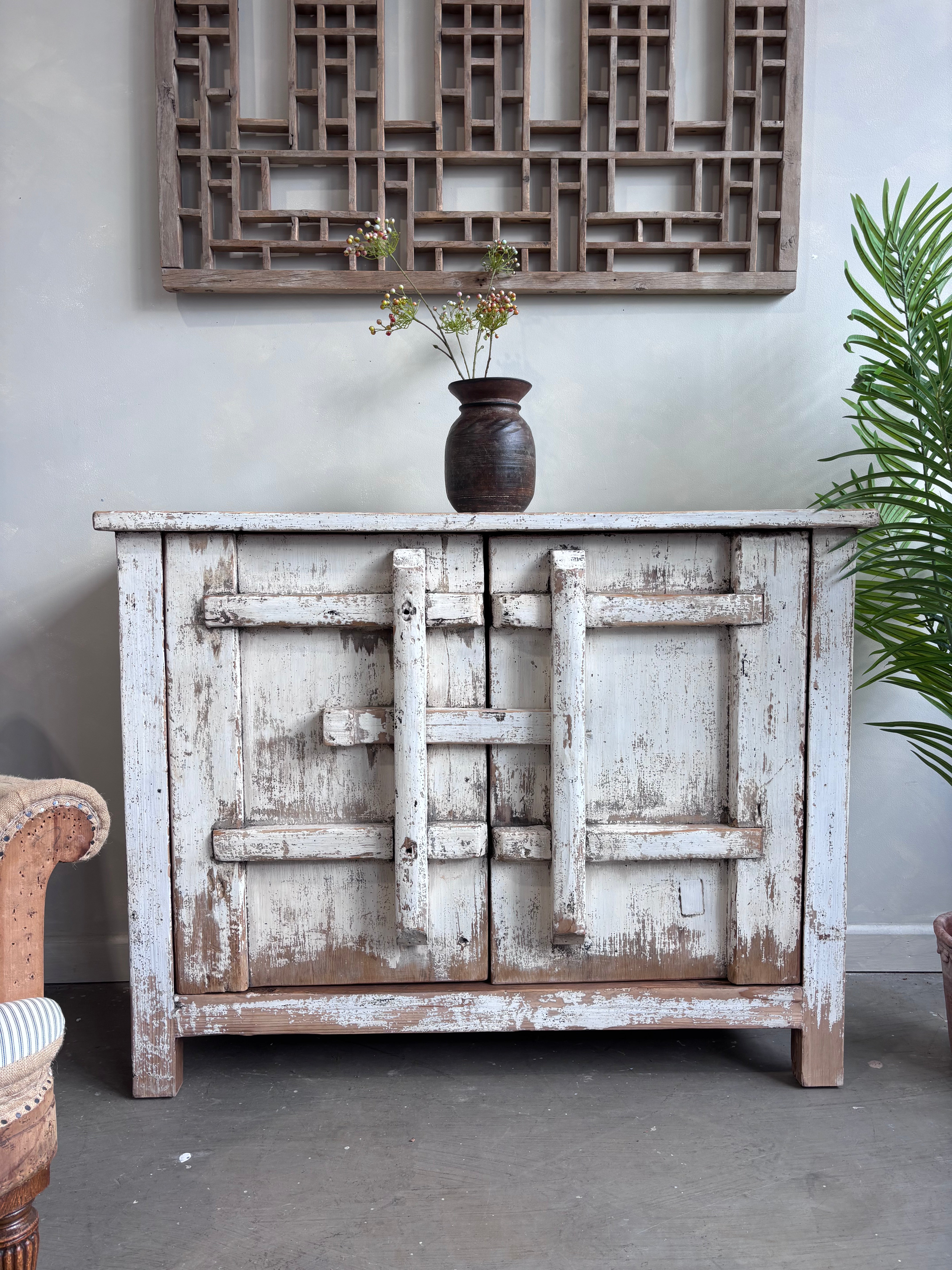 Distressed White Two Door Elm Cabinet with Unique Doors