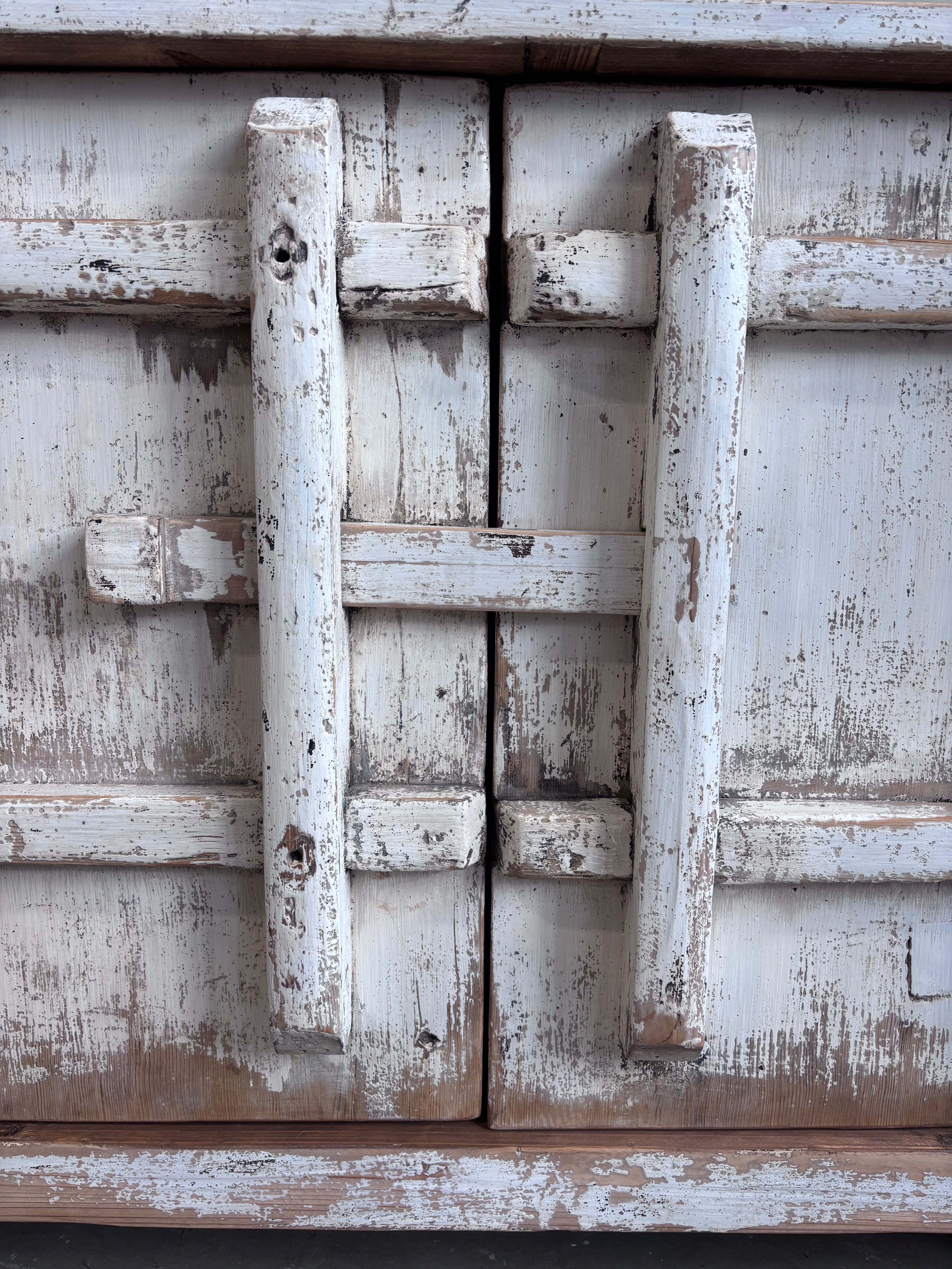 Distressed White Two Door Elm Cabinet with Unique Doors