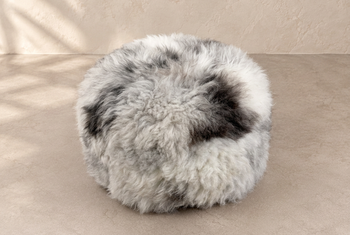 Elevated view showing the natural grey, white and charcoal fleece of a Rare Breed sheepskin pouffe