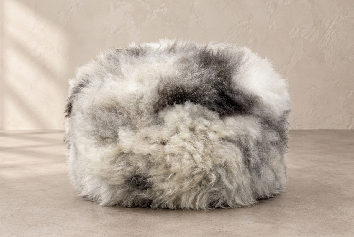 Front view of grey, white and charcoal Rare Breed sheepskin pouffe