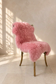 Pink sheepskin draped over a chair